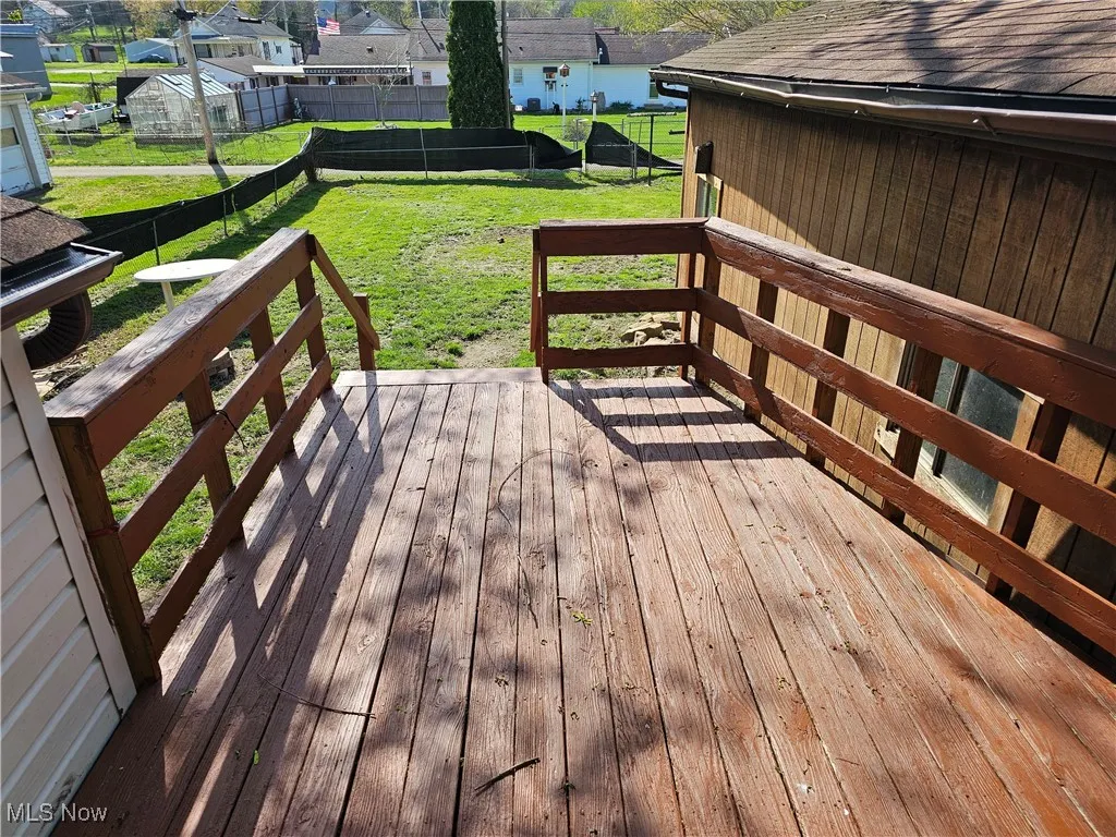 Deck with a lawn, a fenced backyard, and a residential view