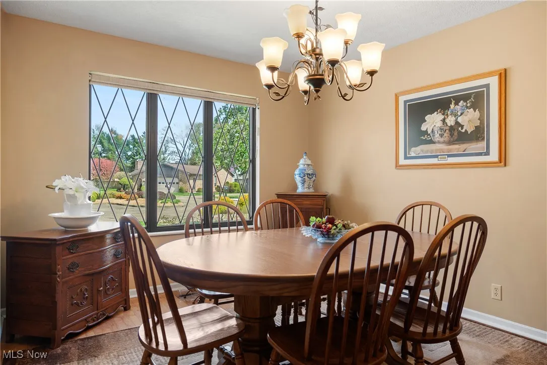 Dining space with baseboards and a notable chandelier