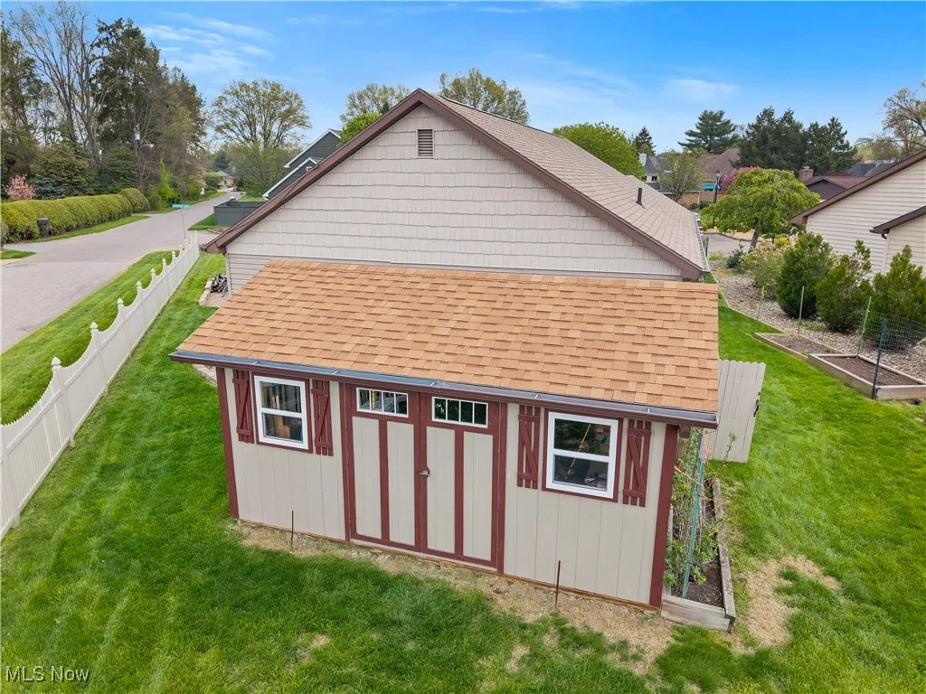 View of shed with a garden and a fenced backyard