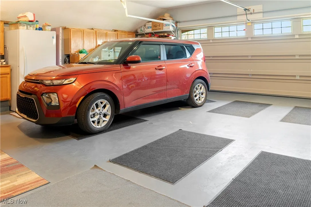 Garage featuring freestanding refrigerator