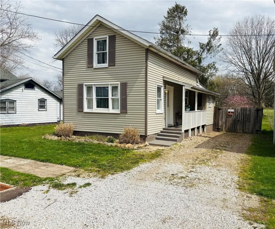 Front view of property with a charming covered front porch.