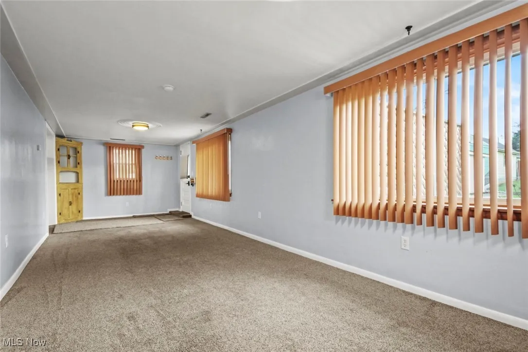 Spare room with carpet flooring and baseboards