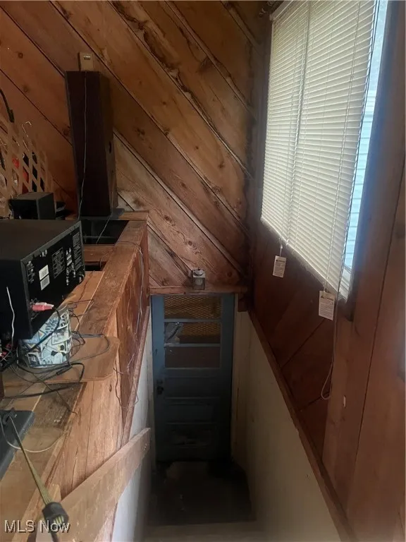Stairs featuring wooden walls