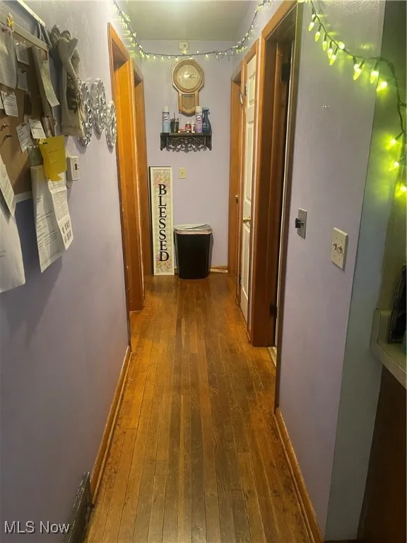 Hall with hardwood / wood-style flooring