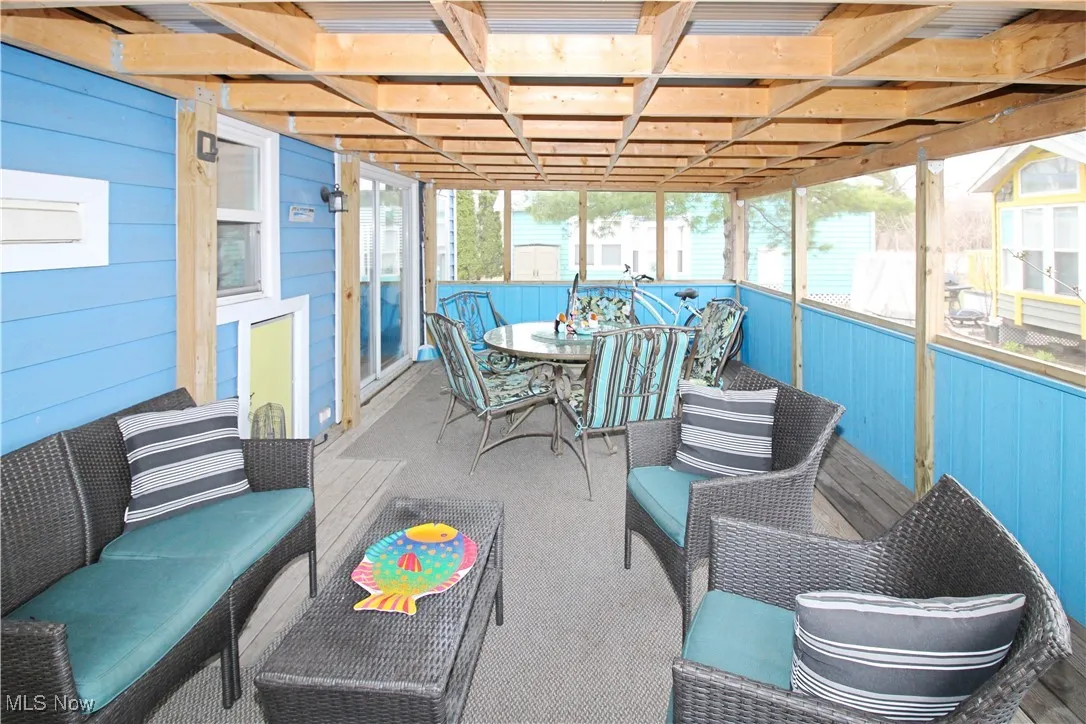 Sunroom featuring outdoor dining area
