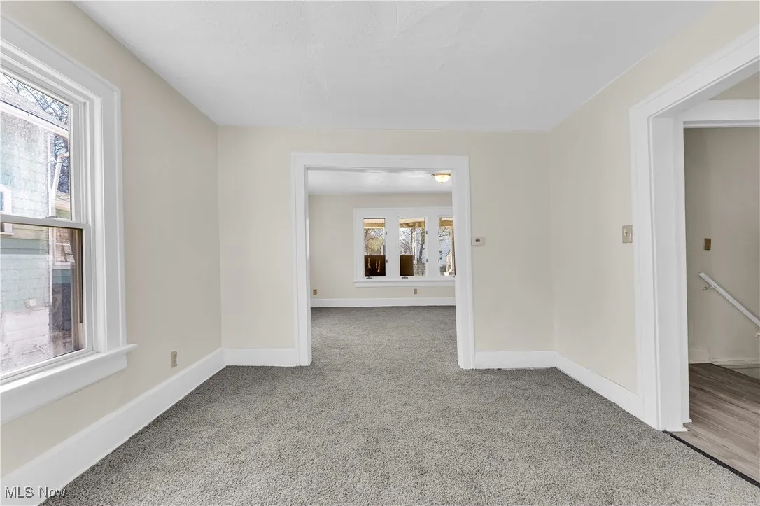 Carpeted spare room with baseboards