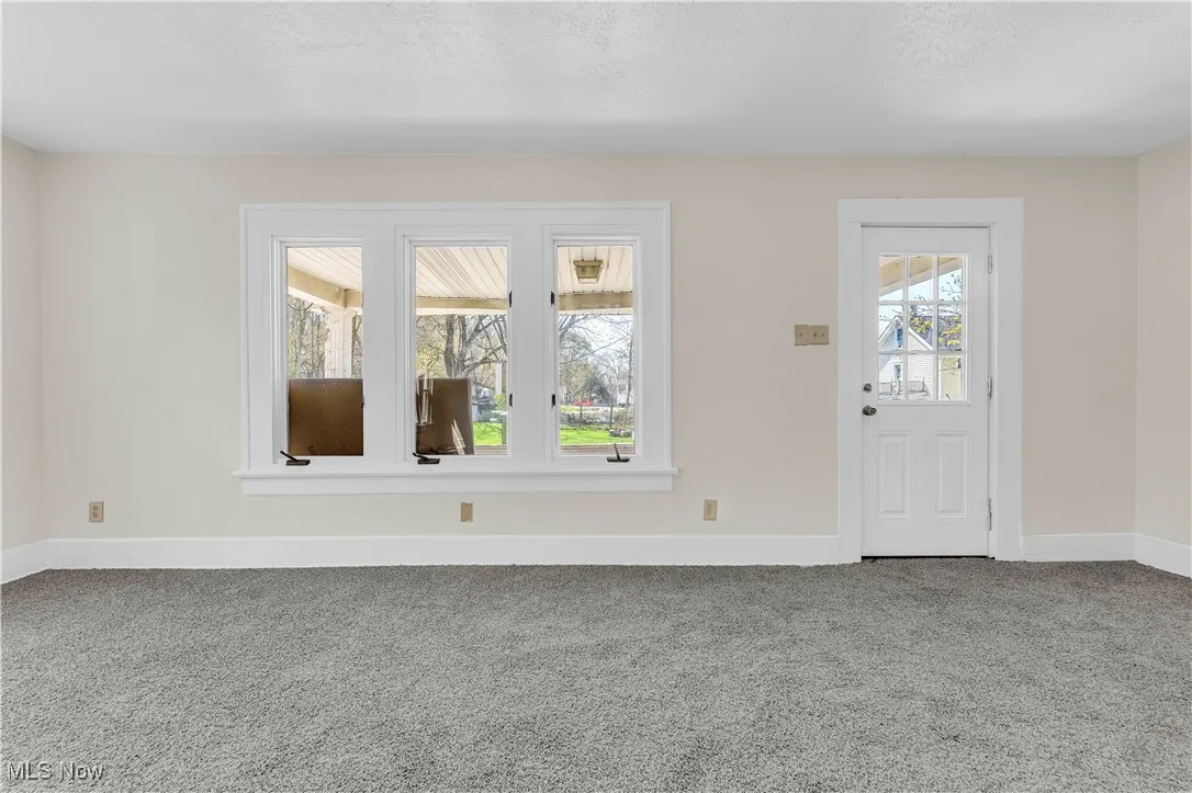 Entryway with baseboards and carpet flooring