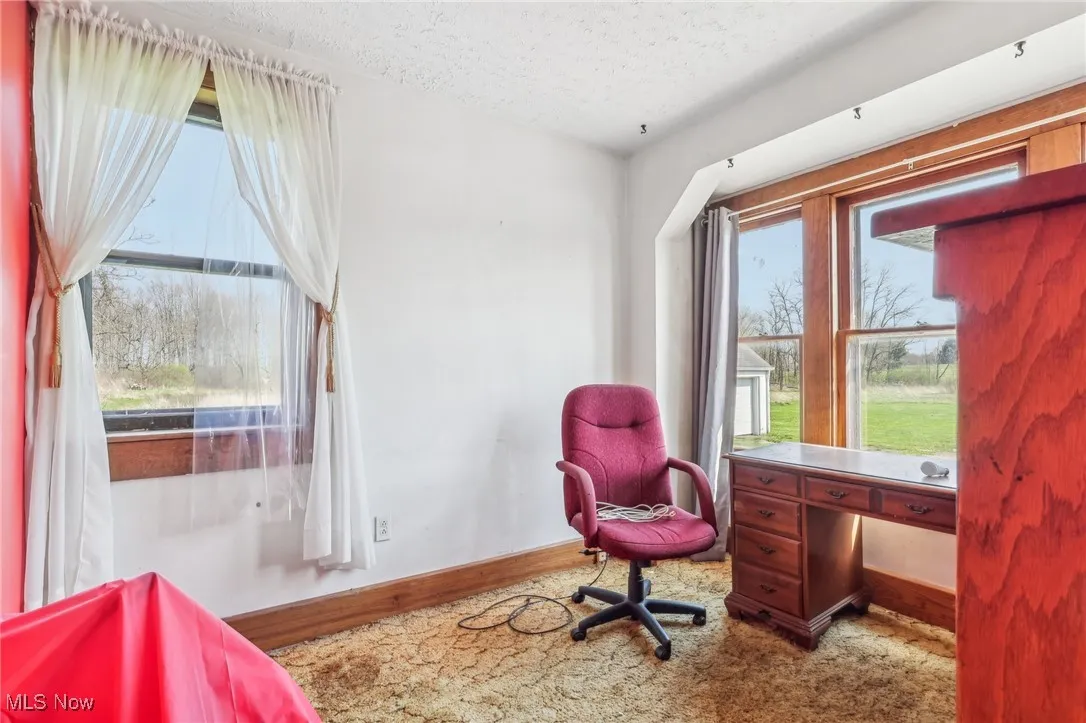 Office with baseboards and a textured ceiling