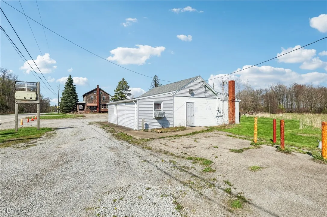 View of side of property featuring driveway and cooling unit