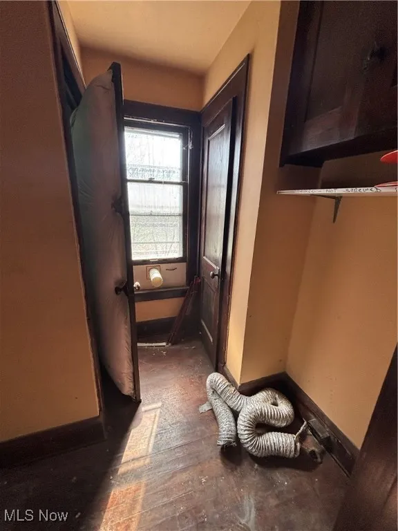 Hallway featuring baseboards