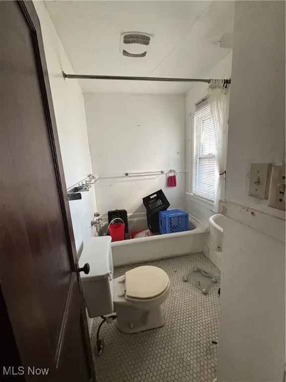 Bathroom with tile patterned floors and toilet