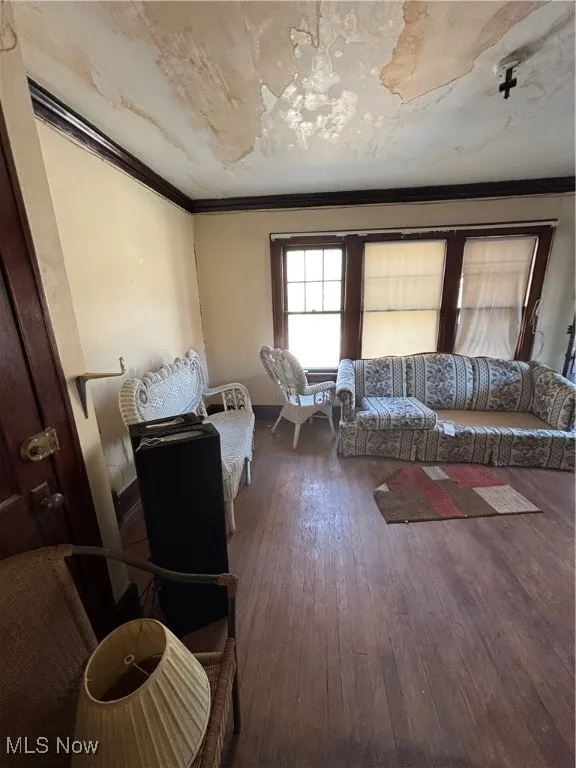 Living room with crown molding and hardwood / wood-style flooring