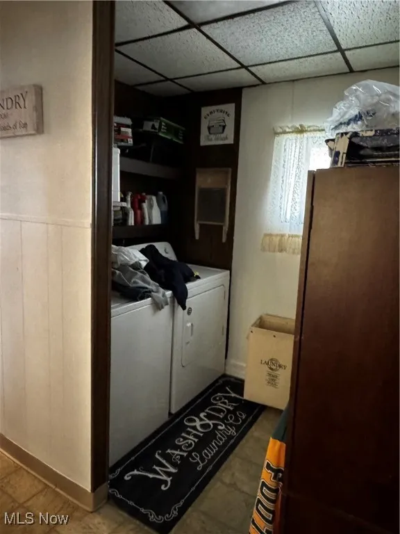 Laundry area featuring washer and dryer, tile patterned floors, and laundry area