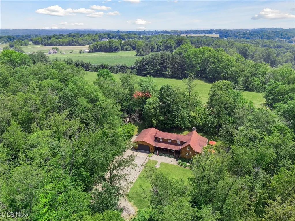 View from above of property with a heavily wooded area