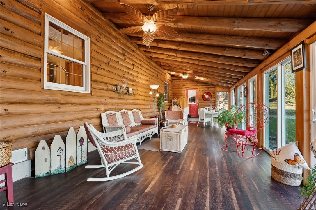 Unfurnished sunroom featuring wooden ceiling and vaulted ceiling with beams