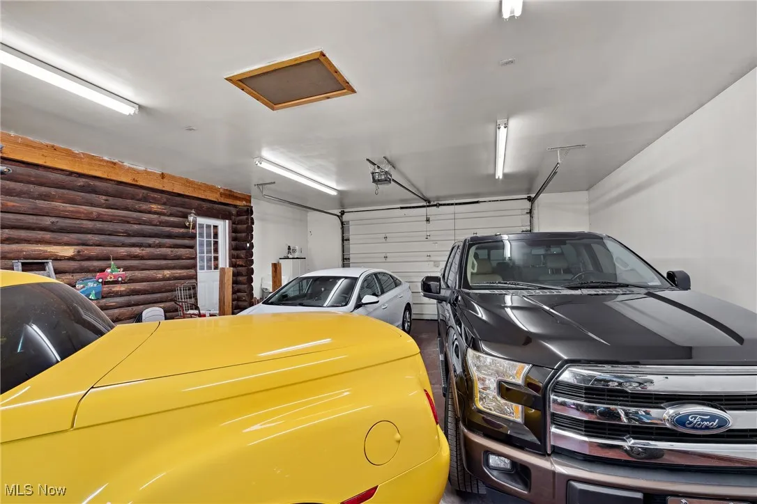 Garage featuring a garage door opener and water heater