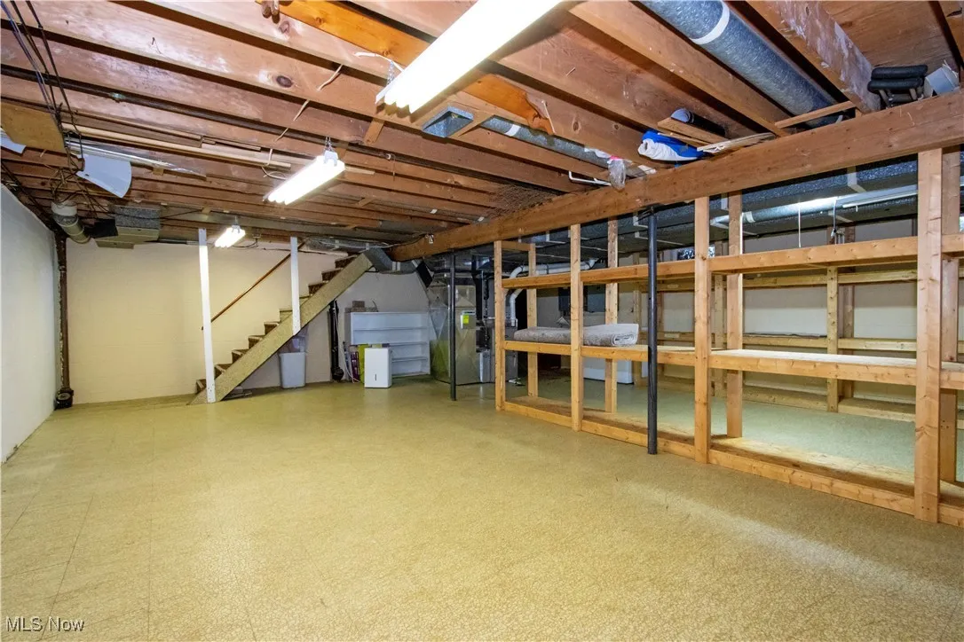 Unfinished basement featuring stairs