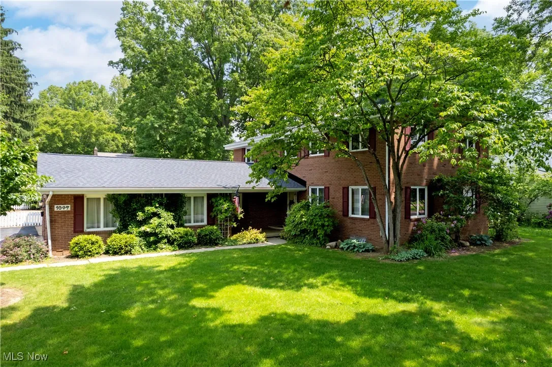 View of front of house featuring a front yard and brick siding