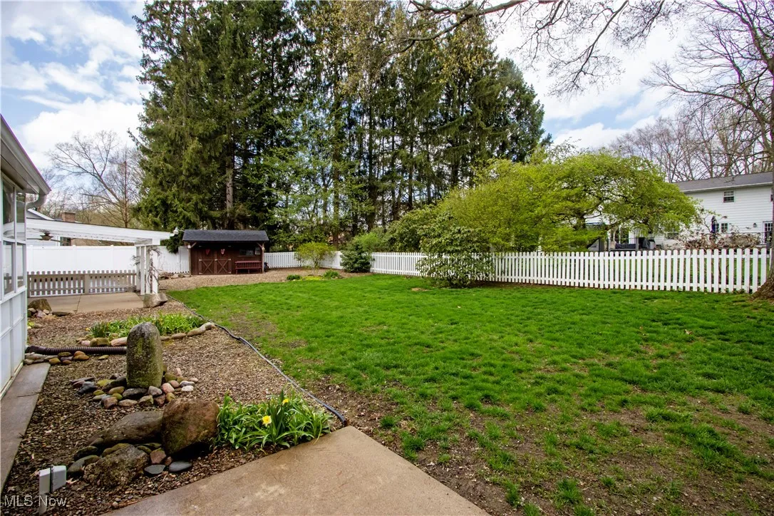 View of yard featuring an outbuilding, a shed, and a fenced backyard