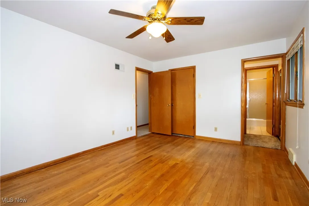 Unfurnished bedroom featuring baseboards, visible vents, and light wood-style floors