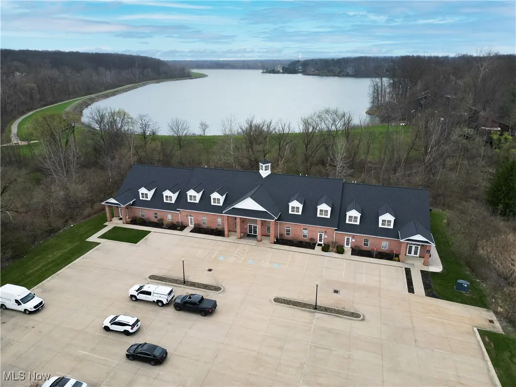 Drone / aerial view featuring a view of trees and a water view