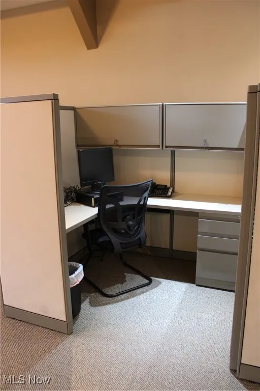 Office featuring built in desk and carpet