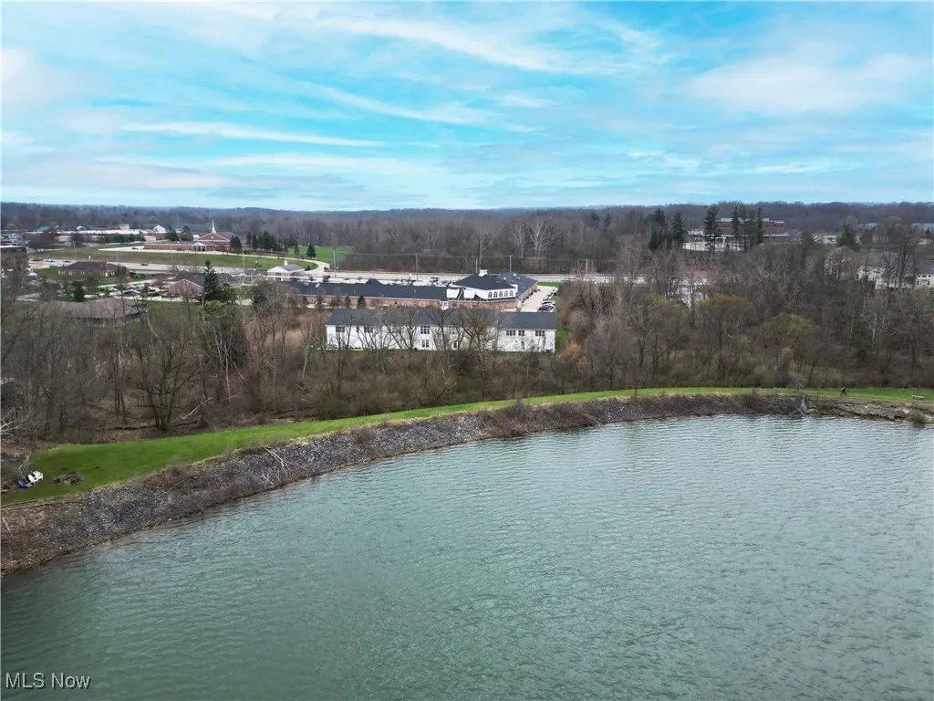 Birds eye view of property with a water view