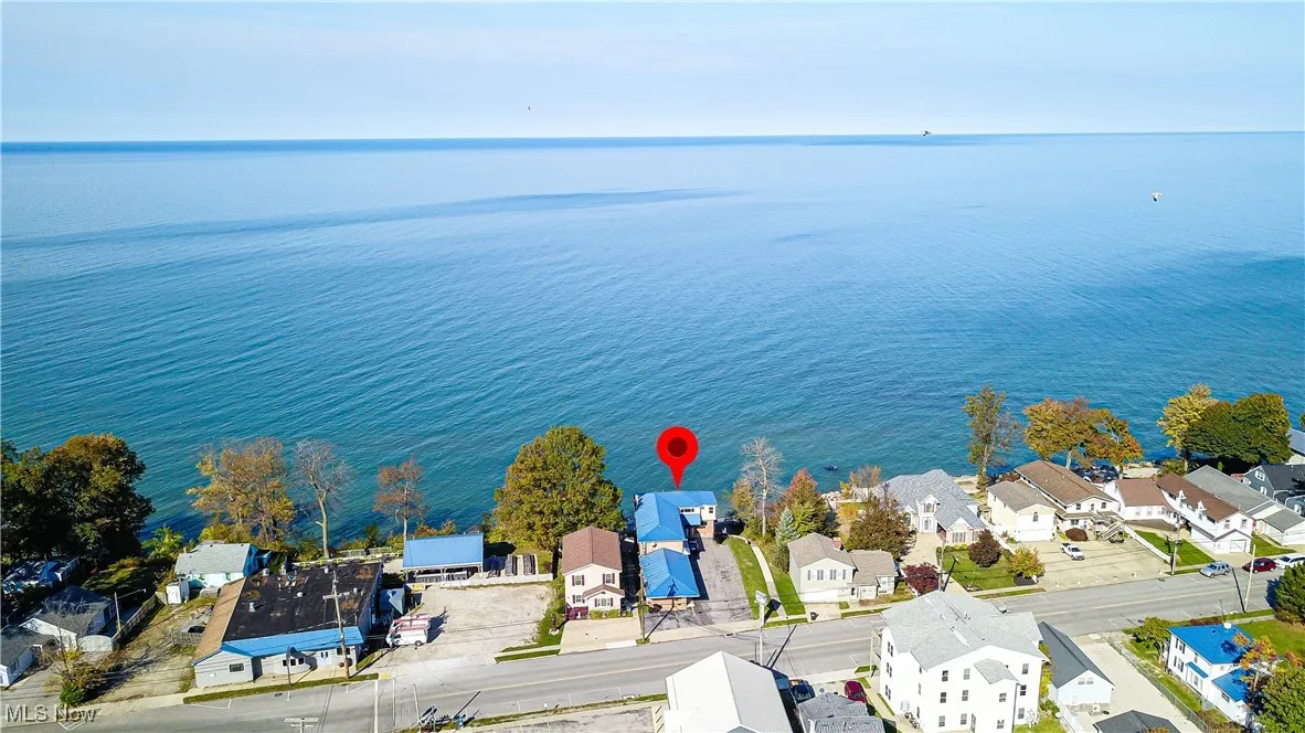 Birds eye view of property with a water view