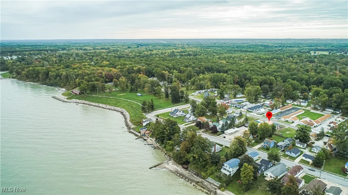Birds eye view of property with a water view