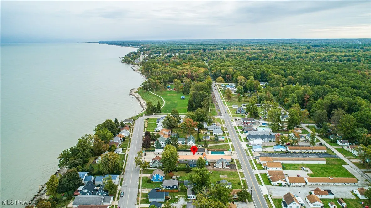 Birds eye view of property with a water view