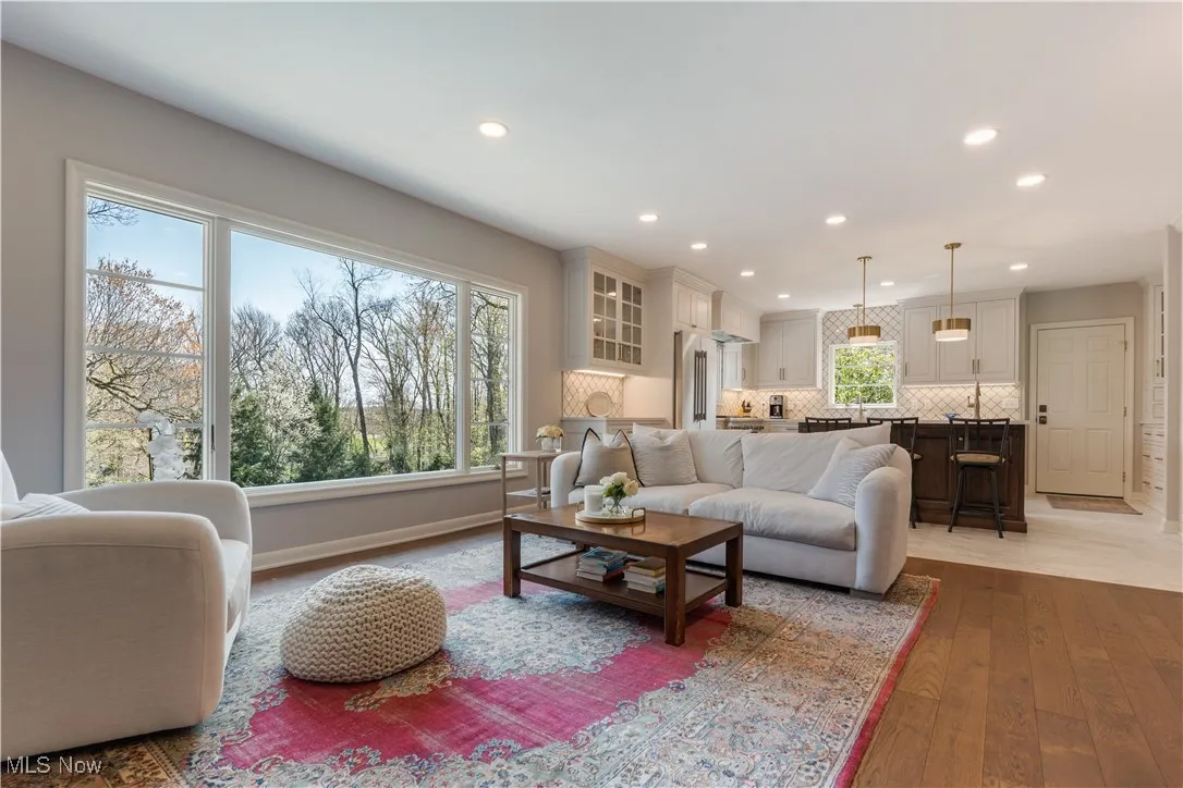 Living room with hardwood / wood-style flooring, baseboards, and recessed lighting