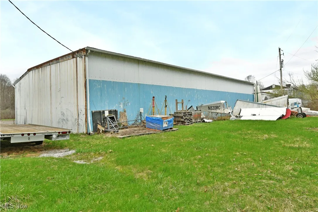View of pole building featuring a lawn