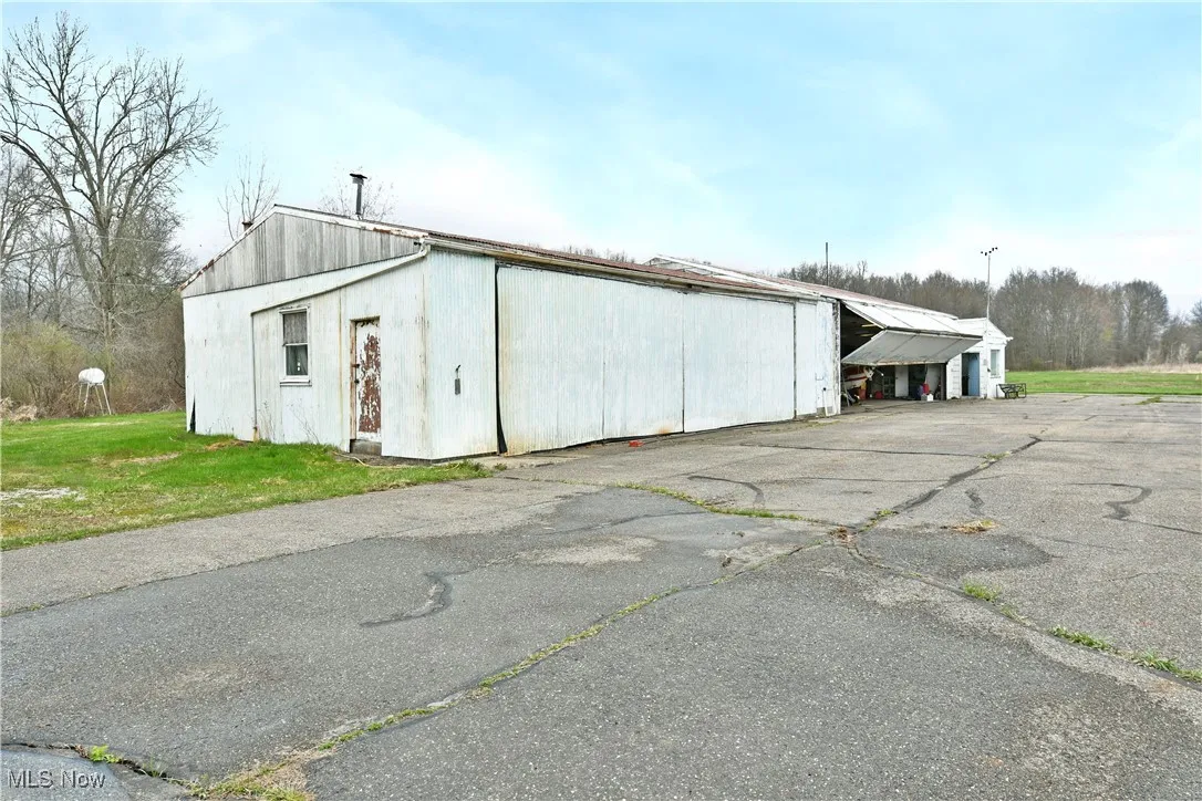 View of pole building featuring a yard