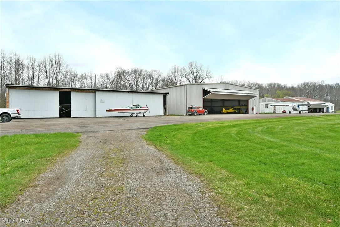 View of pole building with a yard