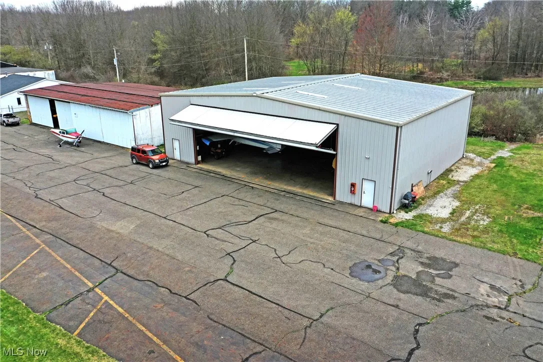 Detached garage featuring a wooded view