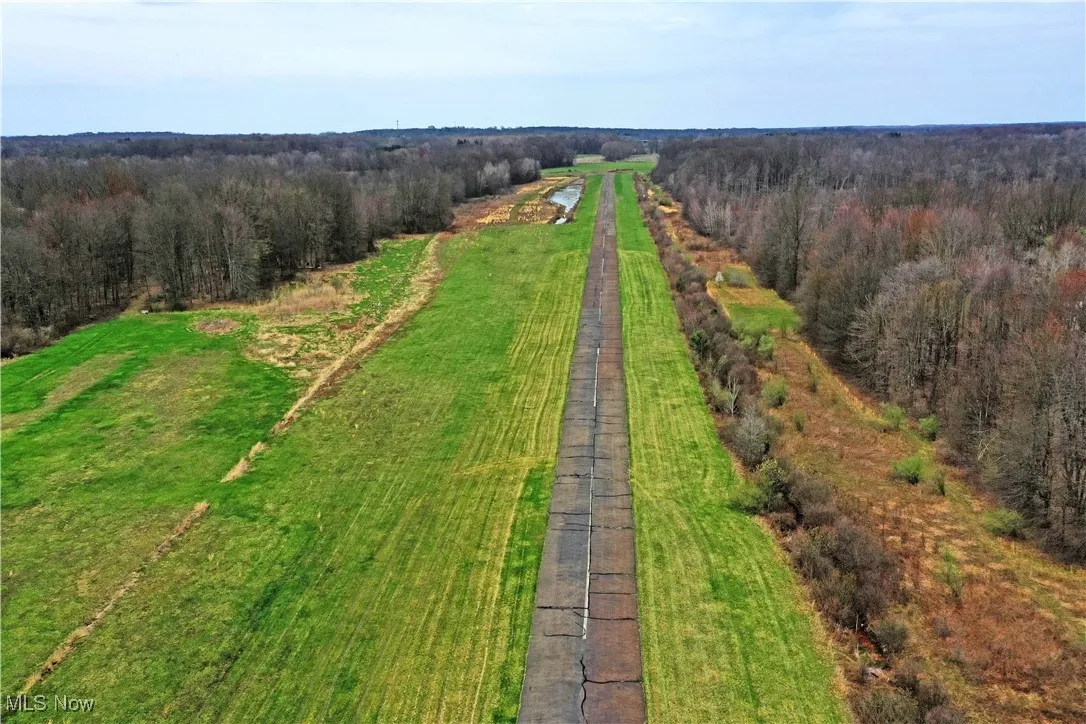 Birds eye view of property with a wooded view and a rural view