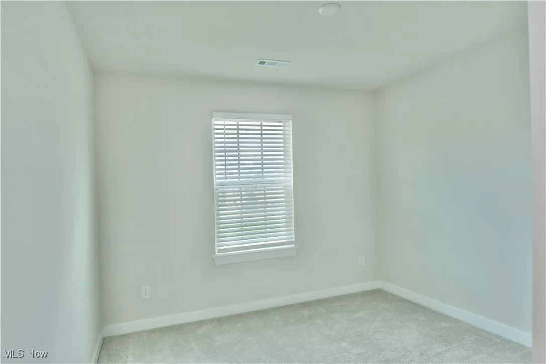 Third bedroom with visible vents and baseboards