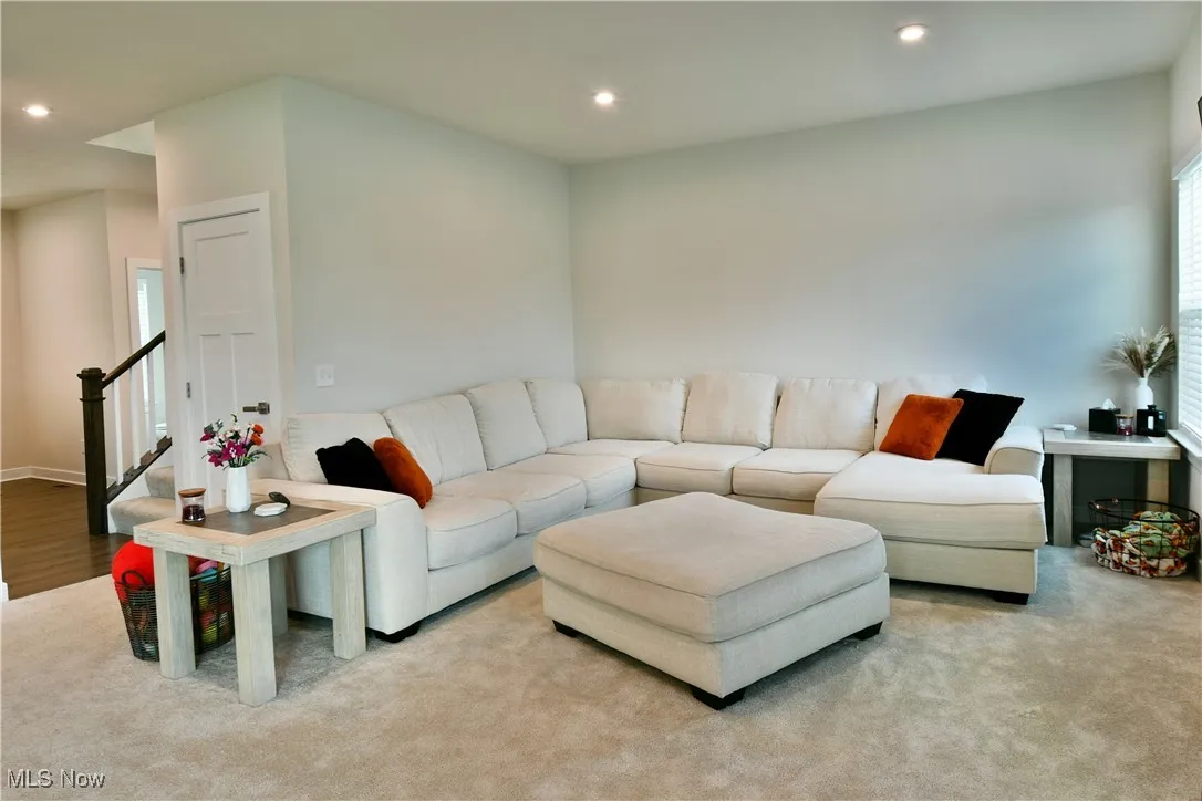 Living room featuring stairway and recessed lighting