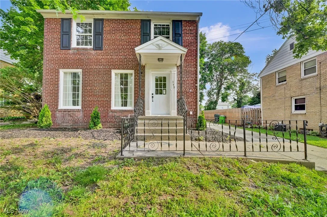 View of front facade featuring brick siding