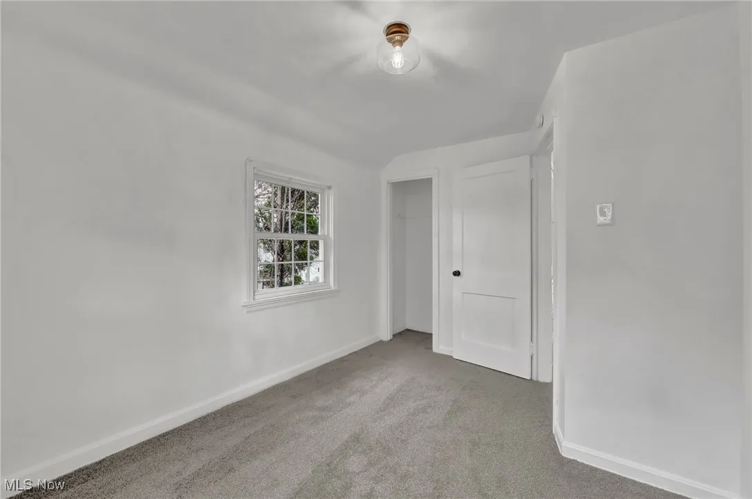 Unfurnished room with baseboards and carpet flooring
