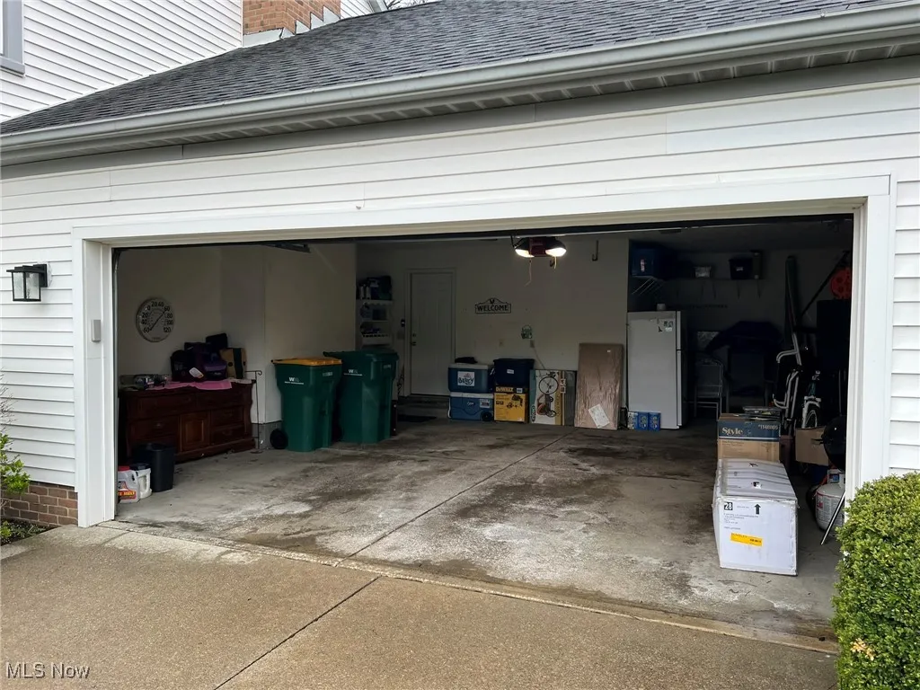 Garage featuring driveway and a garage door opener
