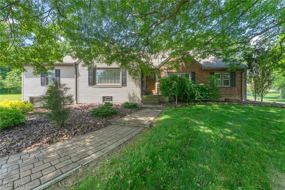 View of front of home with a front yard and brick siding
