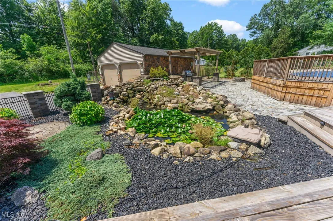 View of yard featuring a deck and an outdoor structure