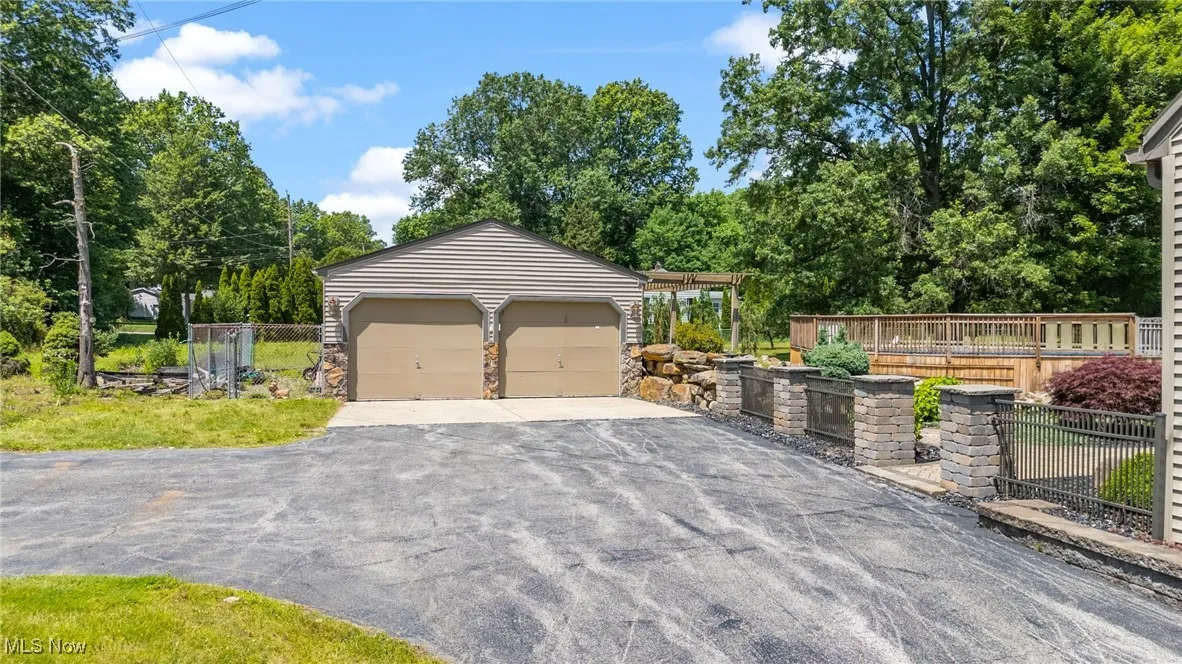 Detached garage with view of wooded area