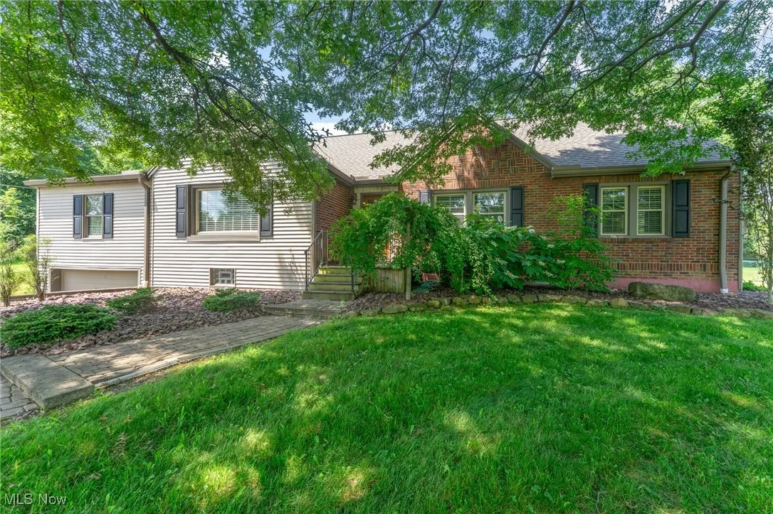 View of front facade with a front yard and brick siding