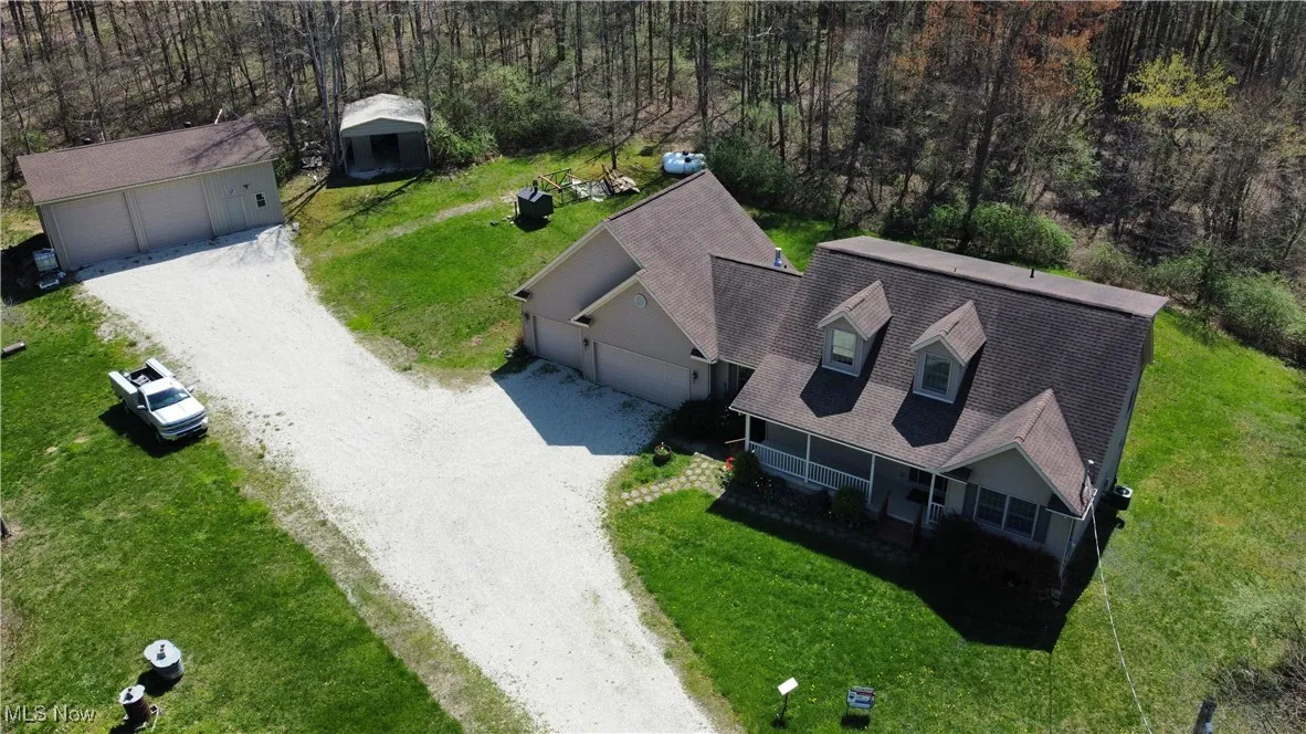 Birds eye view of property featuring a view of trees