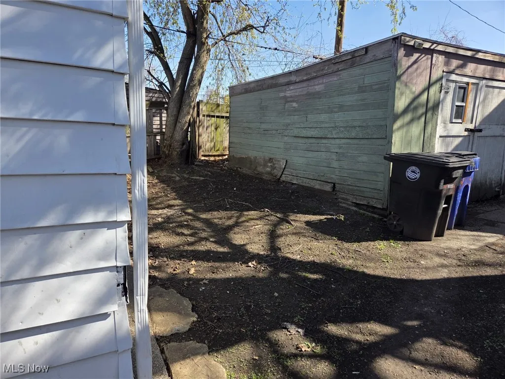 View of side of property featuring an outbuilding and a shed