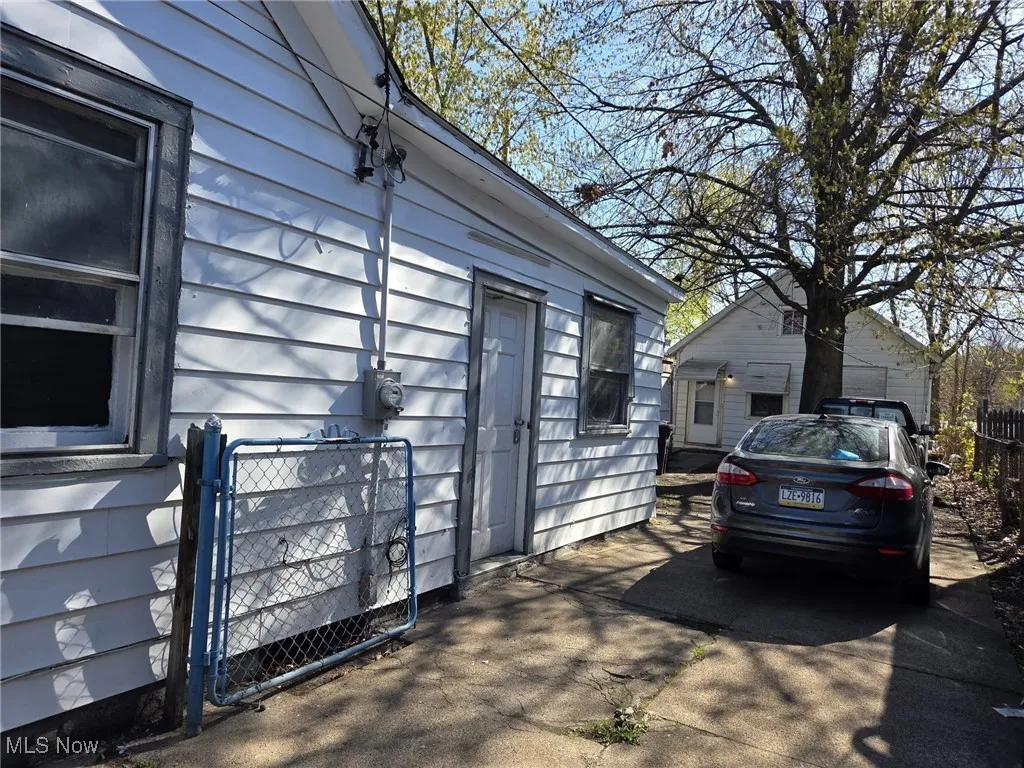 View of property exterior with fence and a gate