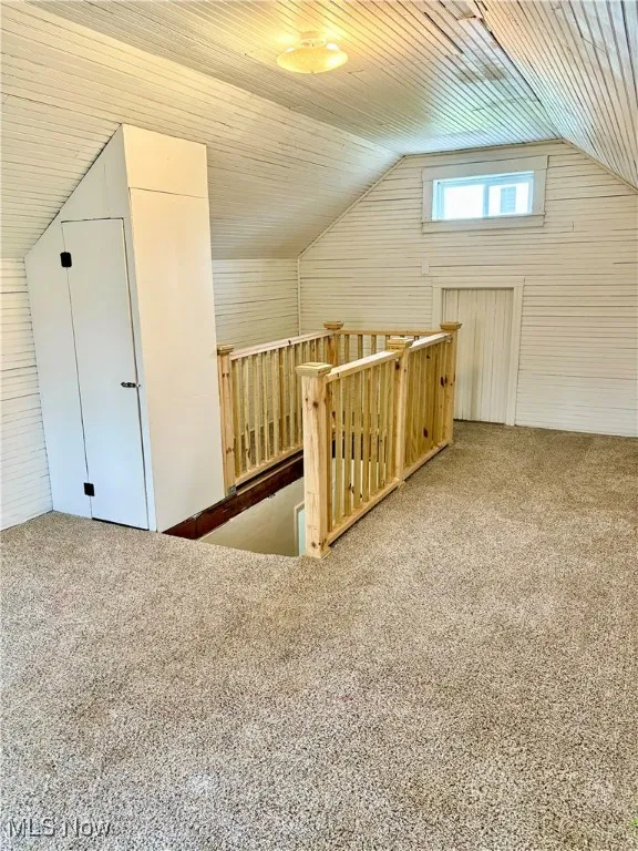 Bonus room featuring lofted ceiling and carpet floors