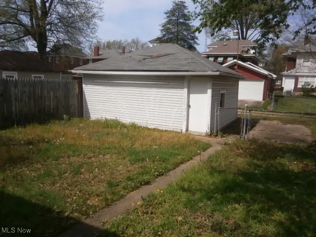 Detached garage featuring fence